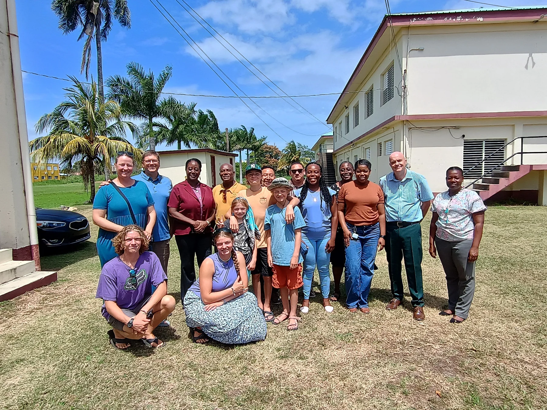 A school and community group gathered outdoors in Belize